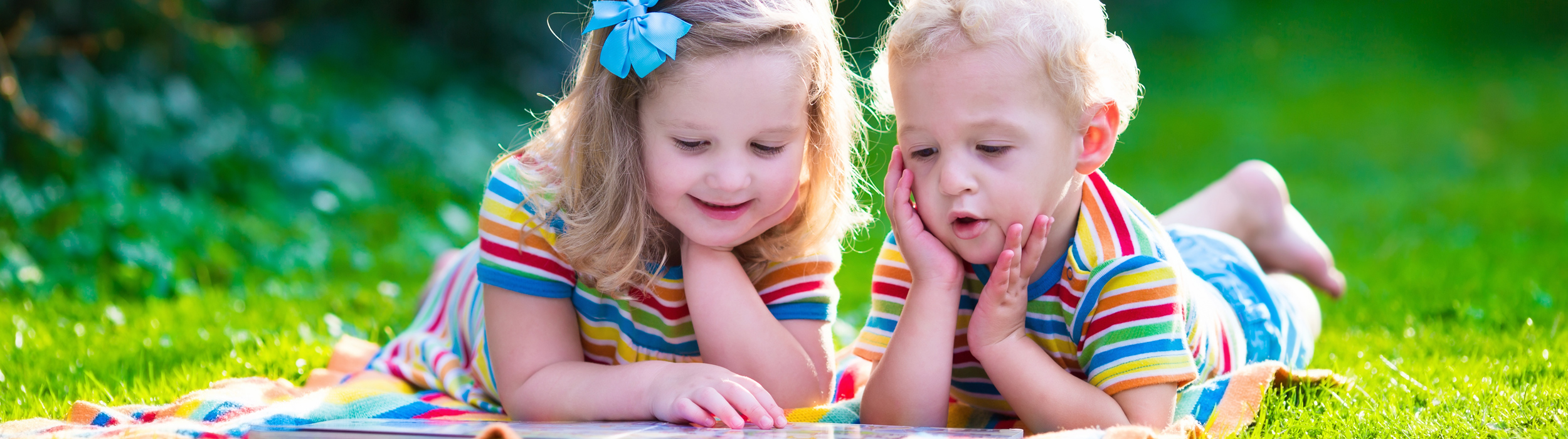 Image of 2 young siblings playing in the back garden